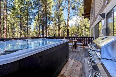 a hot tub on the deck of a house at 1192 Timber Lane home in South Lake Tahoe