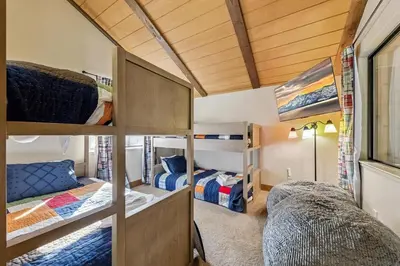 a room with bunk beds and a room with two beds at 1192 Timber Lane home in South Lake Tahoe