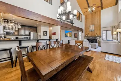 a dining room and living room with a wooden table at 1192 Timber Lane home in South Lake Tahoe