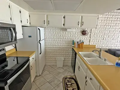 a kitchen with white cabinets and a sink at 439 Ala Wai, 119 condo in South Lake Tahoe