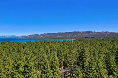 an aerial view of a forest with a lake at 3300 Cape Horn home in South Lake Tahoe