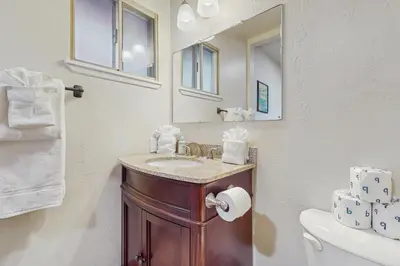a bathroom with a sink and a mirror at Mid-Century Tahoe Ranch House in South Lake Tahoe