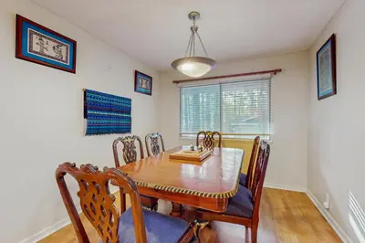 a dining room with a wooden table and chairs at Mid-Century Tahoe Ranch House in South Lake Tahoe