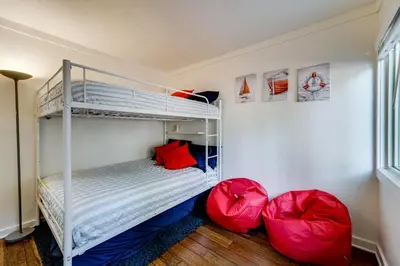 a bedroom with a bunk bed and two red chairs at All-Season Fun! Family Tahoe North Shore Getaway in Incline Village