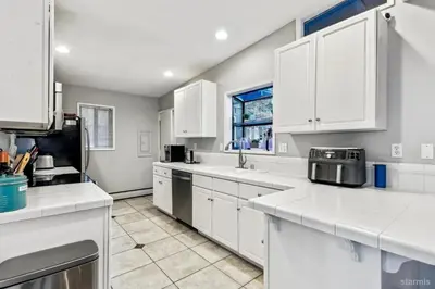 a white kitchen with white cabinets and a window at 3748 Terrace Drive home in South Lake Tahoe