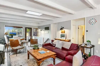 a living room with a red couch and a table at 3748 Terrace Drive home in South Lake Tahoe
