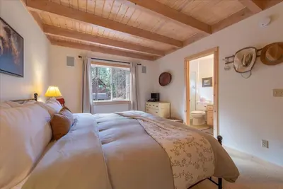 a bedroom with a large bed and a window at Tahoe Pines Beach Retreat home in Homewood