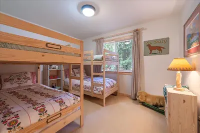 a bedroom with two bunk beds and a window at Tahoe Pines Beach Retreat home in Homewood