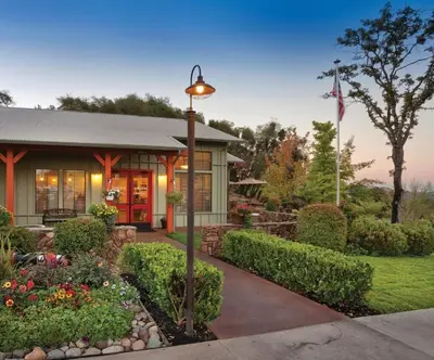 a house with a street light in a garden at Wyndham Angels Camp- 1 BR- Apartment with Resort Access in Angels Camp