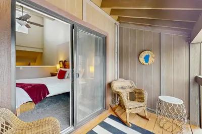 a small room with a bed and a chair at WilderNest in Stateline