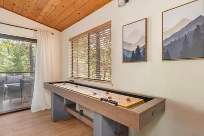 a ping pong table in a room with a window at The Play Pen in Arnold