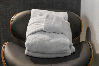 a stack of white towels sitting on a chair at HNC0691 - Tramway Treat home in Stateline