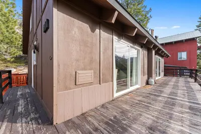 a wooden deck next to a red building at HNC0691 - Tramway Treat home in Stateline