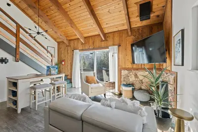 a living room with a couch and a table at HNC0691 - Tramway Treat home in Stateline