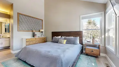 a bedroom with a large bed and a window at Snowcreek V #888 condo in Mammoth Lakes