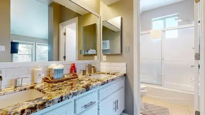 a bathroom with a sink and a toilet and a mirror at Snowcreek V #888 condo in Mammoth Lakes