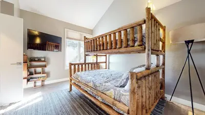 a bedroom with a bunk bed with a ladder at Snowcreek V #888 condo in Mammoth Lakes
