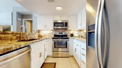 a kitchen with white cabinets and stainless steel appliances at Snowcreek V #888 condo in Mammoth Lakes