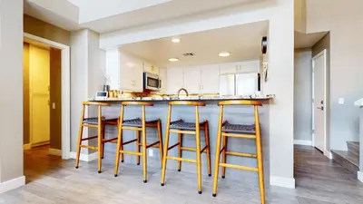 a kitchen with wooden stools at a counter at Snowcreek V #888 condo in Mammoth Lakes