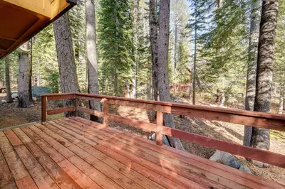 a wooden deck with a view of the woods at Near Slopes, Donner Lake and Trails! Woodsy Retreat in Truckee