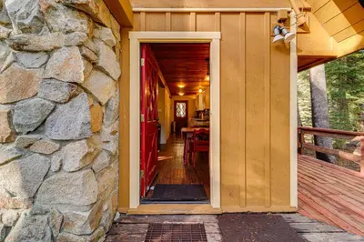 a door to a house with a stone wall at Near Slopes, Donner Lake and Trails! Woodsy Retreat in Truckee
