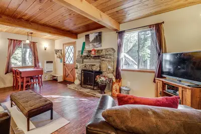 a living room with a couch and a fireplace at Near Slopes, Donner Lake and Trails! Woodsy Retreat in Truckee