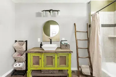 a bathroom with a green vanity and a mirror at 3390 Pine Hill Road home in South Lake Tahoe