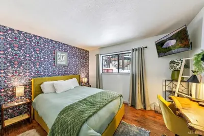 a bedroom with a bed and a floral wall at 3390 Pine Hill Road home in South Lake Tahoe