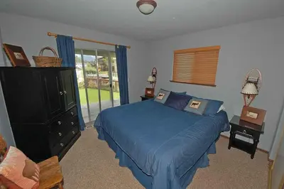 a bedroom with a blue bed and a window at 584 Alpine Drive home in South Lake Tahoe