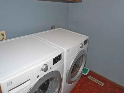 a white washing machine sitting in a room at 584 Alpine Drive home in South Lake Tahoe
