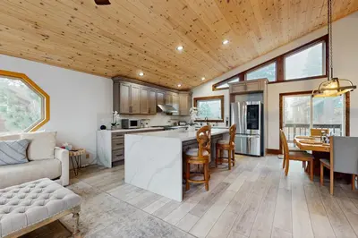 a kitchen and living room with a couch and a table at Hillside Chalet in Truckee