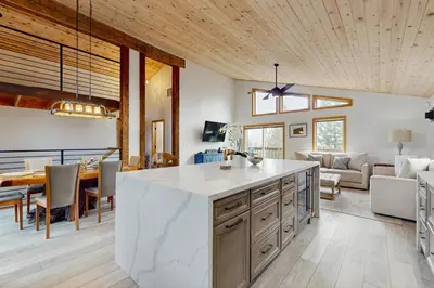 a kitchen and living room with a table and chairs at Hillside Chalet in Truckee