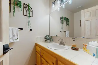 a bathroom with a sink and a mirror at Hillside Chalet in Truckee