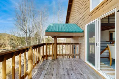 a wooden deck with a green roof on a house at Hillside Chalet in Truckee