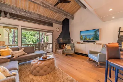 a living room with a couch and a fireplace at Kings Beach Luxe in Kings Beach