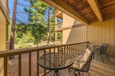 a patio with a table and chairs on a deck at Kings Beach Luxe in Kings Beach