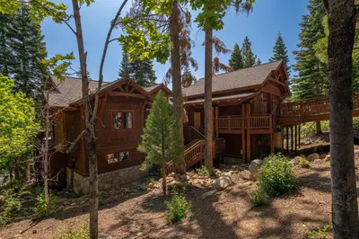 a log home in the woods with trees at Silverfox at Northstar in Truckee