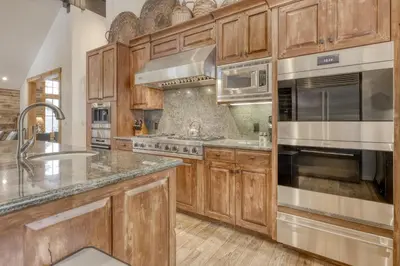 a kitchen with wooden cabinets and stainless steel appliances at Silverfox at Northstar in Truckee