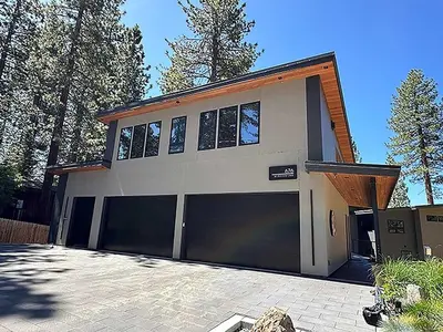 a house with two garage doors in a driveway at 676 El Dorado Avenue home in South Lake Tahoe