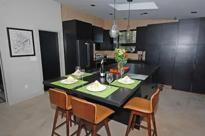 a kitchen with a black island with a table and chairs at 676 El Dorado Avenue home in South Lake Tahoe