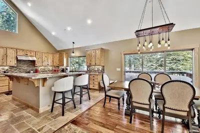a kitchen with a table and chairs and a dining room at 539 Wintoon Drive home in South Lake Tahoe