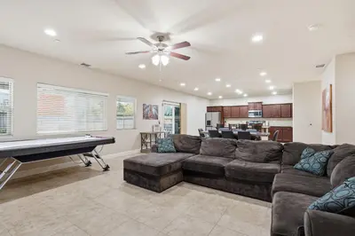 a living room with a couch and a pool table at Casa Cortez in Visalia