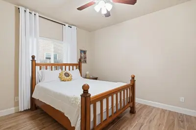 a bedroom with a bed and a ceiling fan at Casa Cortez in Visalia