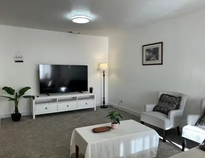 a living room with a large flat screen tv at Downtown 2 Bedrooms Full Kitchen & Easy Parking in Sacramento