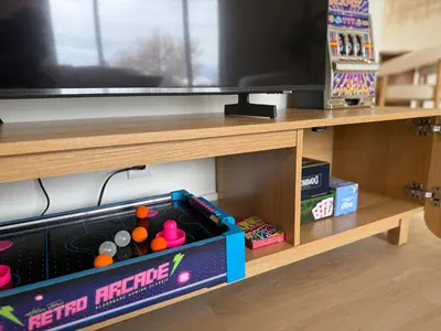 a entertainment center with a television and toys on a shelf at New! Modern 4BR max 12 ppl, 5 mins to everything! in Reno