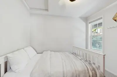 a white bedroom with a bed and a window at Lakeview Getaway at Rubicon Bay in Tahoma