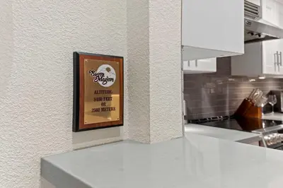 a picture on the wall of a kitchen with a counter at Luxury 3BR 3BA Condo Steps from Canyon Lodge Lift in Mammoth Lakes