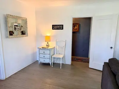 a room with a desk with a lamp and a chair at Cozy Farm House with River access in Three Rivers