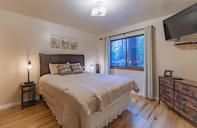 a bedroom with a large bed and a large window at Oglala Little Lodge - For 4 in South Lake Tahoe