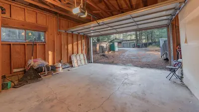 an empty garage with a large sliding glass door at Oglala Little Lodge - For 4 in South Lake Tahoe